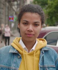 Portrait of Stylish African American Woman in Jean Jacket Standing at City Center